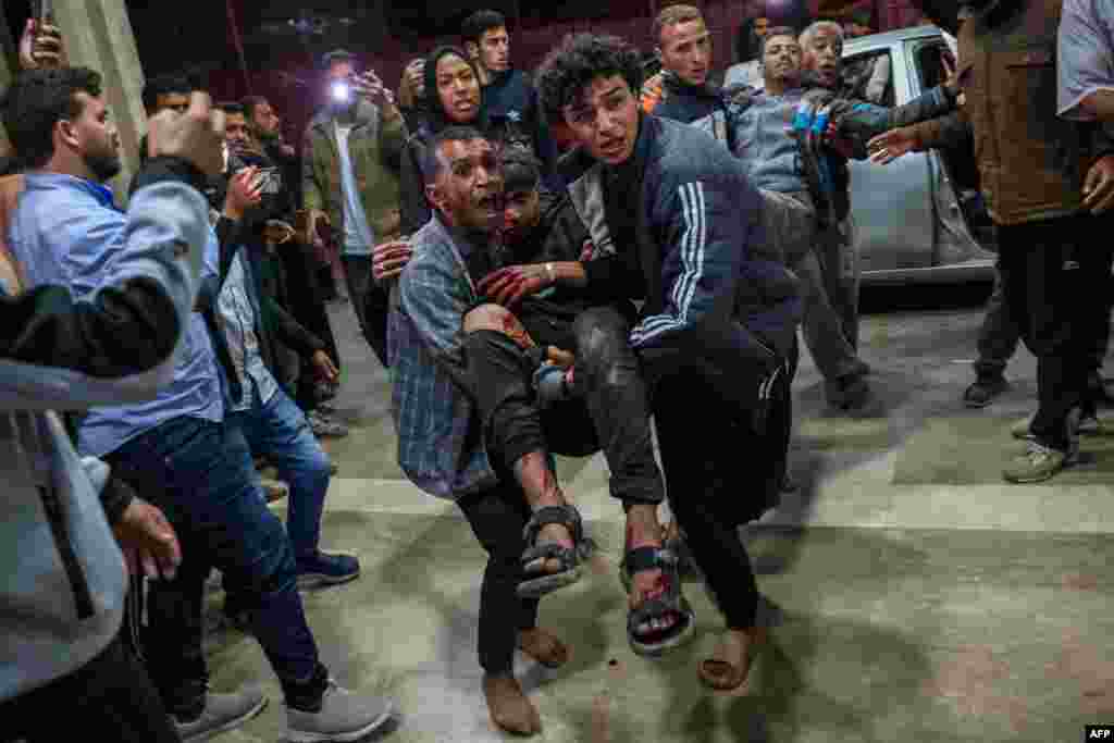 Palestinians bring injured men to Nasser Hospital following an Israeli strike in Khan Yunis, amid the ongoing war between Israel and Hamas.