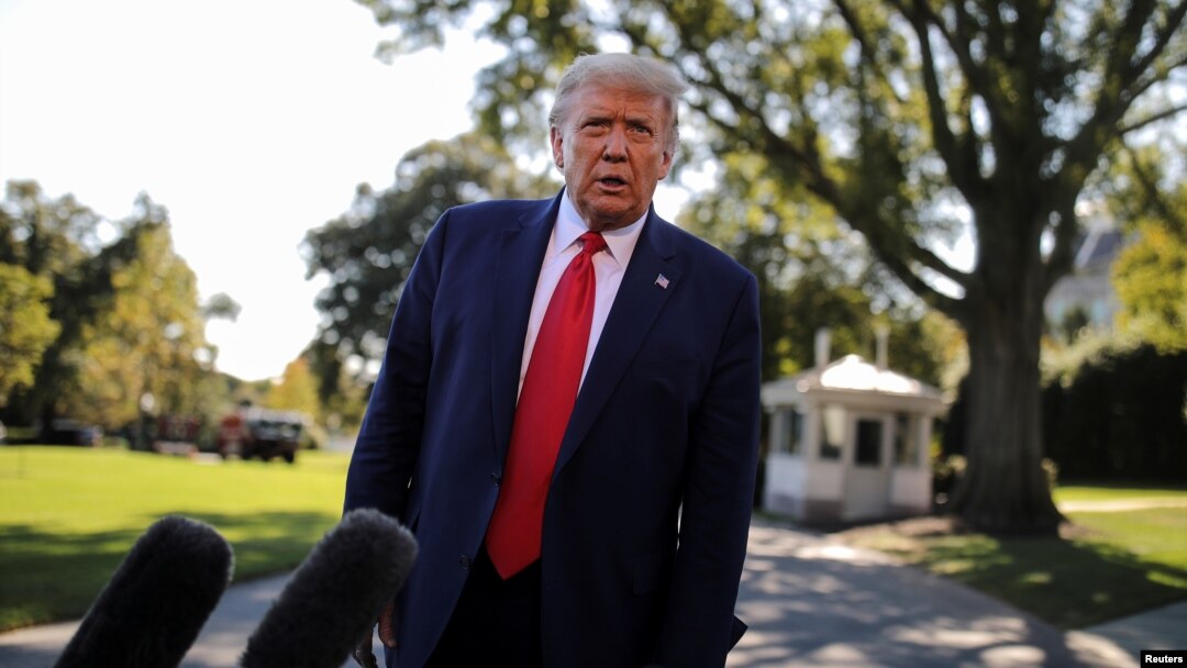 U.S. President Donald Trump talks to reporters as he departs for campaign travel to Ohio from the South Lawn at the White House in Washington, Sept. 21, 2020. 
