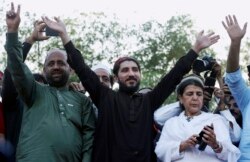 FILE - Manzoor Pashteen, center, a leader of the Pashtun Protection Movement, waves to his supporters during a rally in Lahore, Pakistan, April 22, 2018.