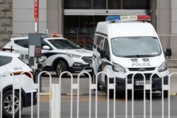 An escorted police van believed to be carrying Huayuan Real Estate Group former chairman Ren Zhiqiang leaves Beijing No. 2 Intermediate People's Court, where Ren faces corruption trial, in Beijing, China, Sept. 11, 2020.