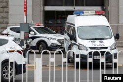 An escorted police van believed to be carrying Huayuan Real Estate Group former chairman Ren Zhiqiang leaves Beijing No. 2 Intermediate People's Court, where Ren faces corruption trial, in Beijing, China, Sept. 11, 2020.