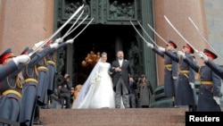 Grand Duke George Mikhailovich Romanov and Victoria Romanovna Bettarini leave St. Isaac's Cathedral after their wedding ceremony in Saint Petersburg, Russia.