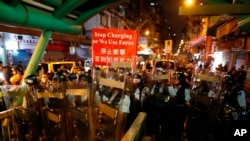 Police move out from the Shum Shui Po police station to confront protesters in Hong Kong on Wednesday, Aug. 14, 2019. 