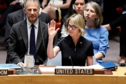 New U.S. Ambassador Kelly Knight Craft raises her hand for her first vote as she attends her first Security Council meeting, at United Nations headquarters, in New York, Sept. 12, 2019.