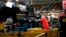 FILE- A technician tightens screws on the front bumper assembly at the Nissan Canton Assembly Plant, in Canton, Miss., March 19, 2018. 