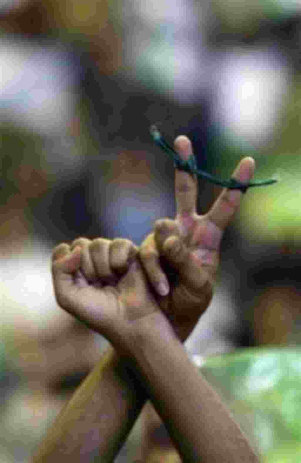 A supporter of Mir Hossein Mousavi, the leading reformist candidate in the upcoming Iranian presidential elections, gestures, during a campaign rally at Tabriz University, Tuesday, May 26, 2009, in Tabriz, Iran. (AP Photo/Hasan Sarbakhshian)
