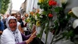 A woman cries beside a truck carrying 136 coffins of newly identified victims of the 1995 Srebrenica massacre, in front of the presidential building in Sarajevo. The recently identified victims will be transported to the memorial center in Potocari where they will be buried on July 11, the anniversary of the massacre when Bosnian Serb forces slaughtered 8,000 Muslim men and boys and buried them in mass graves in Europe&#39;s worst massacre since World War II.