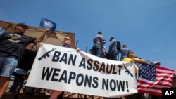 Demonstrators hold a banner to protest the visit of President Donald Trump to the border city after the Aug. 3 mass shooting in El Paso, Texas, Wednesday, Aug. 7, 2019. Trump headed to El Paso, after visiting Dayton, Ohio on Wednesday to offer a…