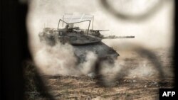 This handout picture released by the Israeli army on June 23, 2024 reportedly shows an Israeli army main battle tank operating in Rafah in the southern the Gaza Strip amid the ongoing conflict in the Palestinian territory between Israel and Hamas.