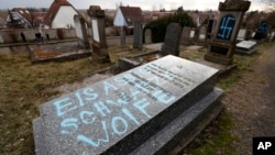 A graffiti reads "Black wolves form Alsace", referring to radical group from the 1970-1980s, is written on a tomb of the Jewish cemetery in Quatzenheim, eastern France, Feb.19, 2019.