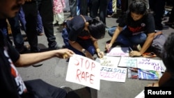 FILE - People make posters during a protest condemning the rape and murder of a trainee medic at a government-run hospital, in Kolkata, India, October 15, 2024. 