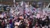 Supporters of impeached South Korean President Yoon Suk Yeol stage a rally to oppose a court having issued a warrant to detain Yoon, near the presidential residence in Seoul, South Korea, Jan. 3, 2025. The letters read, "Oppose Impeachment." 