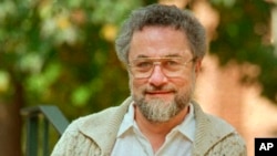 FILE - Adrian Cronauer, a disc jockey on the Saigon-based Dawn Buster radio show from 1965 to 1966 whose experiences in the Vietnam War were chronicled in the movie "Good Morning, Vietnam," poses outside his home in Philadelphia, Pa. Cronauer died July 18, 2018.