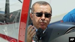 Turkish Prime Minister Recep Tayyip Erdogan in the cockpit of Hurkus (Freebird), Turkey's first locally produced military training plane, outside Ankara, Turkey, June 27, 2012 (AP).