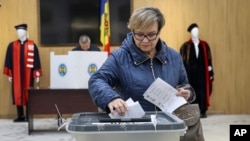 (FILE) A woman casts her vote during local elections in Chisinau, Moldova, Sunday, Nov. 5, 2023.