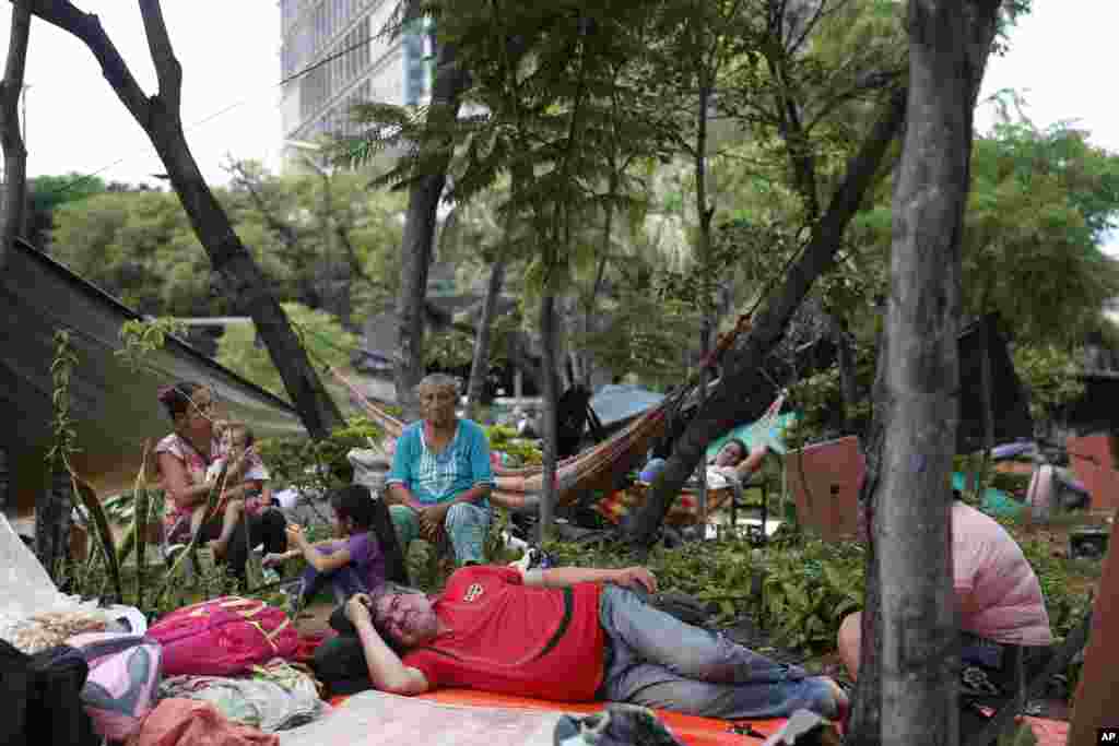 A farming family from Caaguazu camp in a downtown square in a protest calling for the resignation of President Mario Abdo Benitez over his handling of the new coronavirus pandemic and the state of the public health system, in Asuncion, Paraguay.