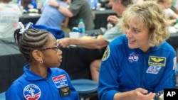 In this file photo from July 13, 2018, NASA astronaut Dottie Metcalf-Lindenburger chats with Space Camp camper Bria Jackson, Atlanta, before giving a speech at the US Space & Rocket Center in Huntsville , To the.  Space Camp.
