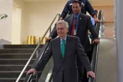 Senate Majority Leader Mitch McConnell of Kentucky rides the escalator to a briefing on election security on Capitol Hill in Washington, July 10, 2019.