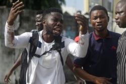 Alister, a protester who says his brother Emeka died from a stray bullet from the Army, reacts while speaking to Associated Press near Lekki toll gate in Lagos, Nigeria, Oct. 20, 2020.