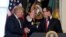 FILE - President Trump shakes hands with Treasury Secretary Mnuchin at the Treasury Department, April 21, 2017, where the president signed an executive order to review tax regulations set last year by his predecessor, as well as memos to potentially reconsider major elements of the 2010 Dodd-Frank financial reforms passed in the wake of the Great Recession.
