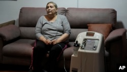 Cancer patient Linda Vidal, who relies on an electricity-powered oxygen concentrator to breathe properly, sits for an interview to talk about her physical and mental health amid the electricity cuts, in Quito, Ecuador, Oct. 24, 2024.