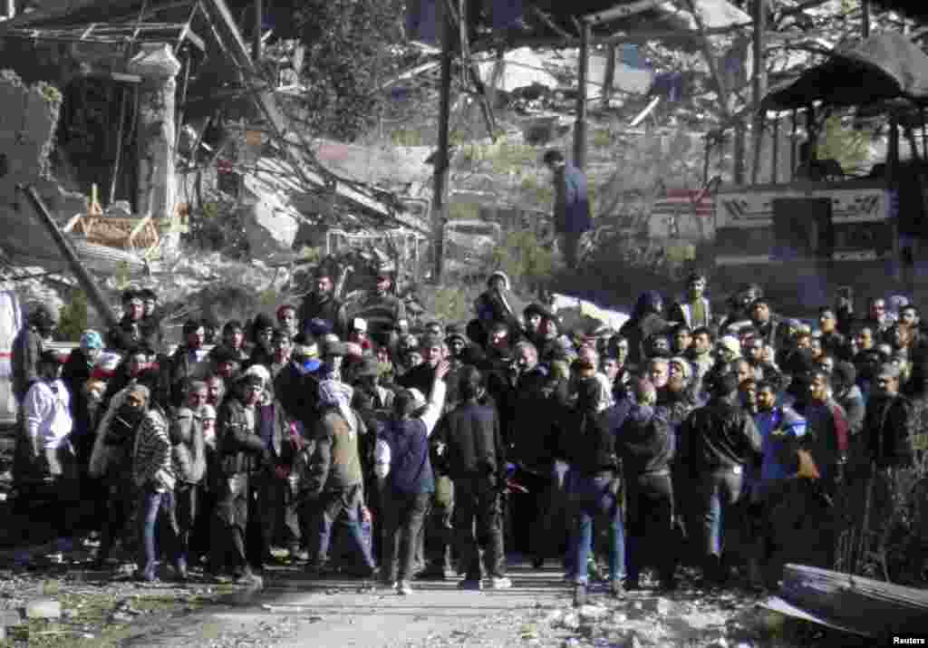 Civilians wait to be evacuated from a besieged area of Homs, Feb. 12, 2014. 