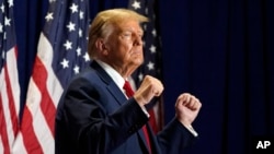 FILE - Republican presidential candidate former President Donald Trump gestures at a campaign rally, March 2, 2024, in Richmond, Va. The U.S. Supreme Court ruled that former President Donald Trump can stay on the 2024 presidential primary ballots. (AP Photo/Steve Helber, File)