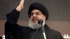 Pemimpin Hizbullah Lebanon Sayyed Hassan Nasrallah berpidato di hadapan para pendukungnya selama prosesi keagamaan untuk memperingati Ashura di pinggiran kota Beirut, Lebanon, 14 November 2013. (Foto: REUTERS/Khalil Hassan)