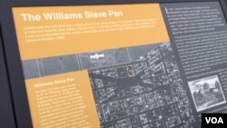 The government unveiled two plaques detailing the location of a notorious slave prison outside the Federal Aviation Administration headquarters in Washington, D.C. (C. Simkins/VOA)