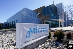 FILE - A sign marks the entrance of the Micron Technology automotive chip manufacturing plant on Feb. 11, 2022, in Manassas, Va. (AP Photo/Steve Helber, File)