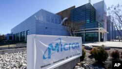 FILE - A sign marks the entrance of the Micron Technology automotive chip manufacturing plant in Manassas, Virginia, Feb. 11, 2022.