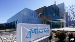 FILE - A sign marks the entrance of a Micron Technology chip manufacturing plant on Feb. 11, 2022, in Manassas, Va.
