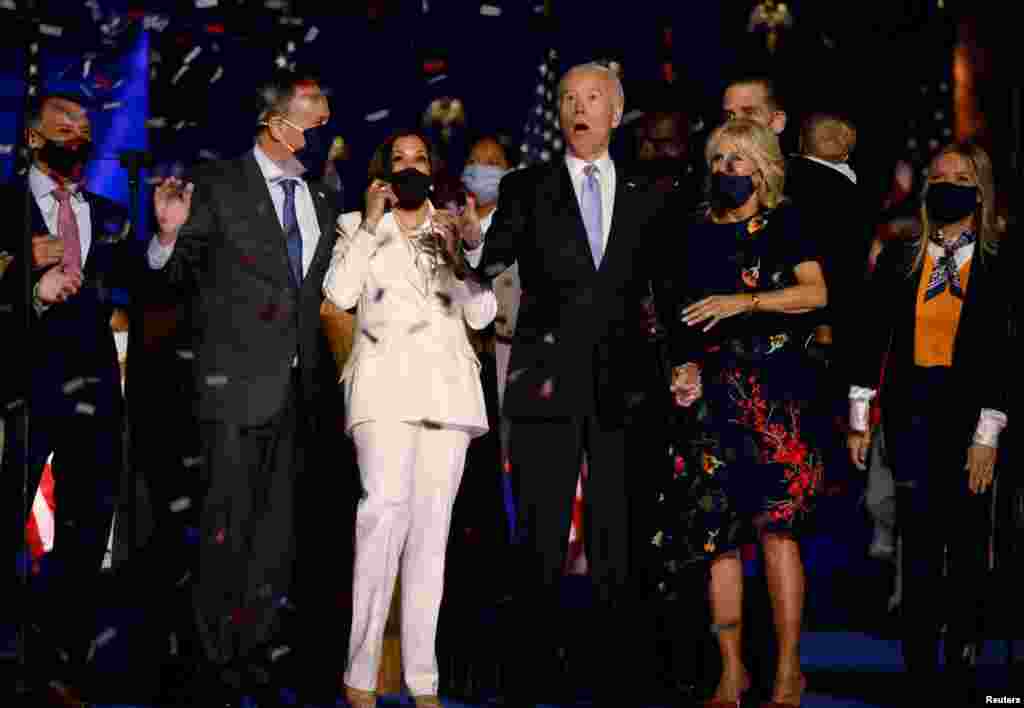 Democratic 2020 U.S. presidential nominee Joe Biden and his wife Jill, and Democratic 2020 U.S. vice presidential nominee Kamala Harris and her husband Doug, react to the confetti at their election victory speeches.