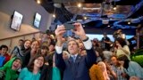 Secretary of State John Kerry takes a selfie with a group of students before delivering a speech on climate change in Jakarta, Indonesia, Feb. 16, 2017.