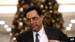 Newly-assigned Lebanese Prime Minister Hassan Diab speaks to journalists after his meeting with Lebanese President Michel Aoun at the presidential palace, in Baabda, east of Beirut, Lebanon, Dec. 19, 2019.