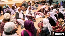 People from the minority Yazidi sect take refuge in a building in Shikhan, January 19, 2015.