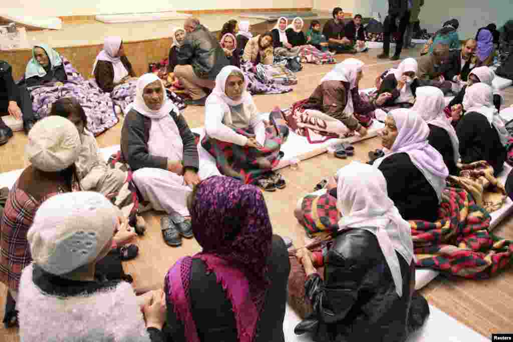 People from the minority Yazidi sect take refuge in a building in Shikhan, January 19, 2015.