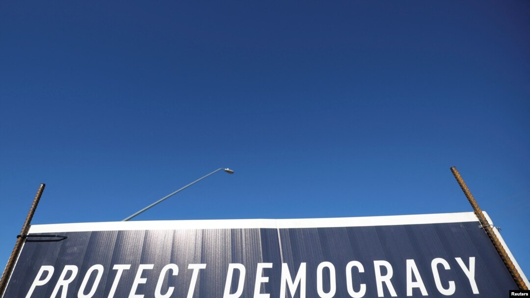 A campaign sign with the slogan "Protect Democracy" stands in Tuscon