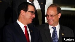 U.S. Secretary of the Treasury Steven Mnuchin talks to Financial Action Task Force President Marshall Billingslea as they pose for the official photo at the G-20 Meeting of Finance Ministers in Buenos Aires, Argentina, July 21, 2018. 