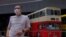 Occupy Central leader Benny Tai stands in front of a vintage double-deck bus used as a polling center for voting in Hong Kong Saturday, July 11, 2020, in an unofficial “primary” for pro-democracy candidates ahead of legislative elections in September.