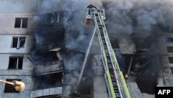 Firefighters work to extinguish a blaze in a residential apartment building following a Russian strike, in Kharkiv, northeastern Ukraine, Sept. 15, 2024.