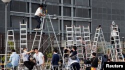 Members of the media wait for the former Nissan Motor Chariman Carlos Ghosn to leave the Tokyo Detention House in Tokyo, April 25, 2019.
