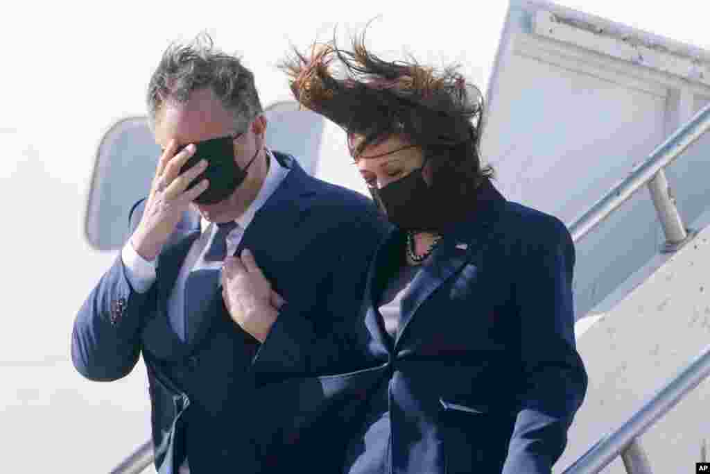 Vice President Kamala Harris and her husband, Doug Emhoff, walk off Air Force Two after their arrival in Los Angeles, March 15, 2021.