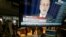 The news conference of Federal Reserve Chairman Ben Bernanke appears on a television screen at a trading post on the floor of the New York Stock Exchange, Dec. 18, 2013.