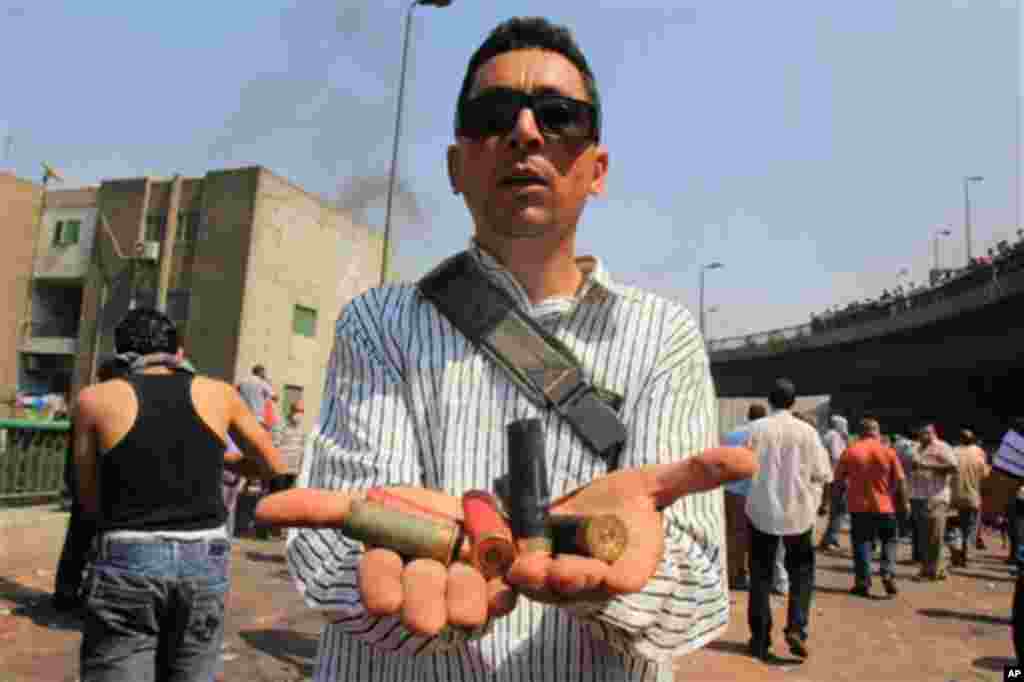 A supporters of Egypt's ousted President Mohammed Morsi shows spent ammunition during clashes with security forces.