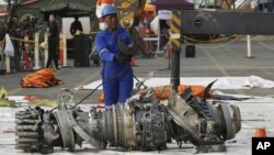 Officials move an engine recovered from the crashed Lion Air jet for further investigation in Jakarta, Indonesia, Nov. 4, 2018.