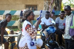 Katungo Methya, 53, who volunteers for the Red Cross educating the public about epidemics, talks about coronavirus prevention in Beni, eastern Congo, April 7, 2020.