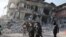 FILE: Turkish police officers walk past by a damaged building as they patrol, in the aftermath of a deadly earthquake in Hatay, Turkey February 11, 2023