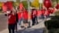 Teachers and students wave to motorists outside Paseo Verde Elementary, April 18, 2018, in Peoria, Ariz. 