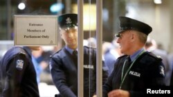 Police officers are seen inside the Parliament, as demonstrators block the streets around it, in Valletta, Malta, Dec. 2, 2019.